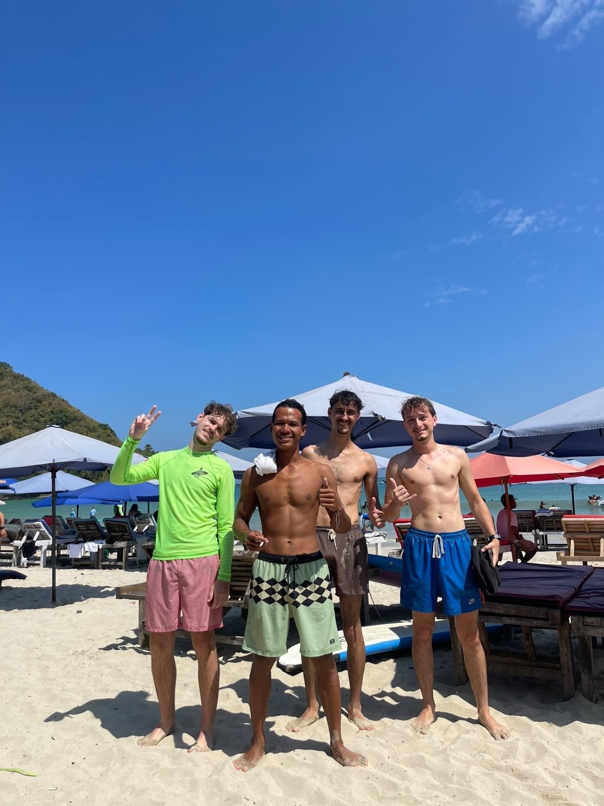 Group of travelers on the beach after a surf lesson