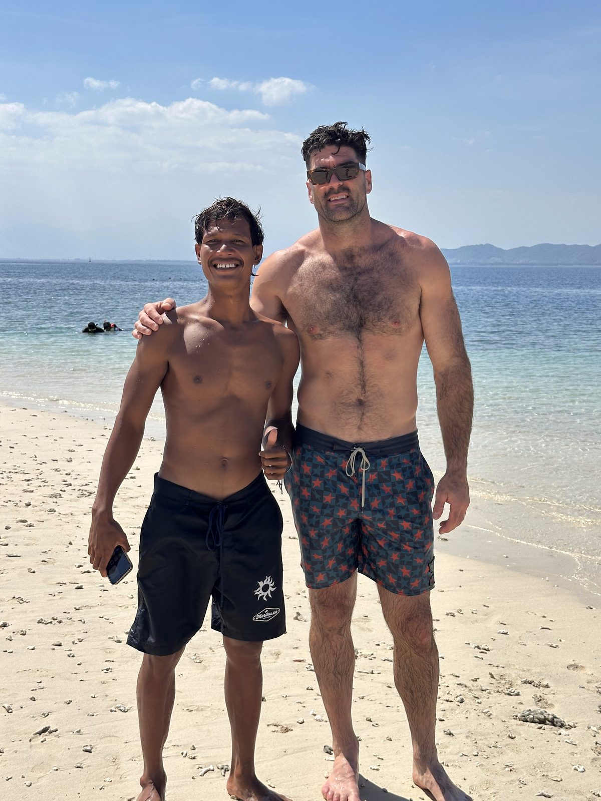 Wawan with a traveler on the beach in Lombok