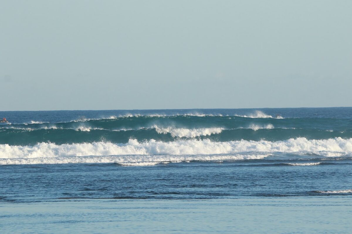 Wave breaking with a fishing buoy in the background
